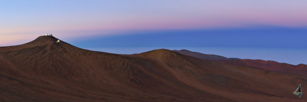 Paranal observatory and surrounding mountains during sunset.
